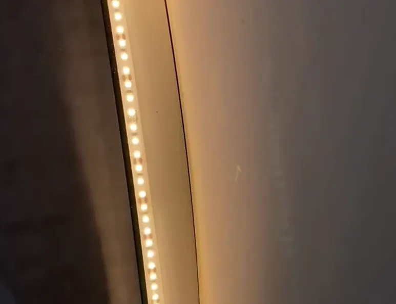 Close-up of LED backlit mirrors with integrated energy-efficient LED strips.