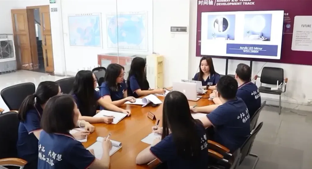 Aosmay engineering team discussing custom LED mirror design with an international client